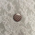 Brown and pink stripy small badge